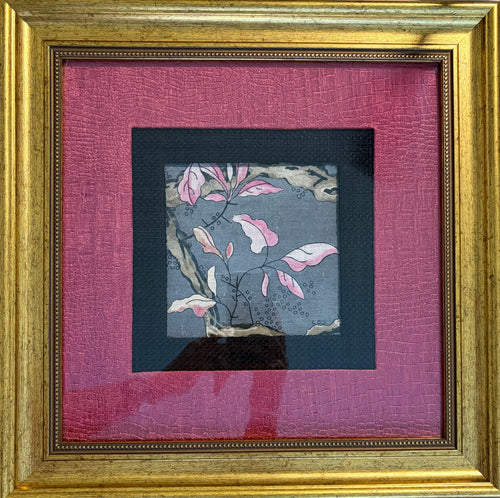 A framed art print featuring a delicate painting of pink and white cherry blossoms on a textured gray background, surrounded by a black inner mat and a vibrant magenta outer mat, all enclosed in an ornate gold frame.