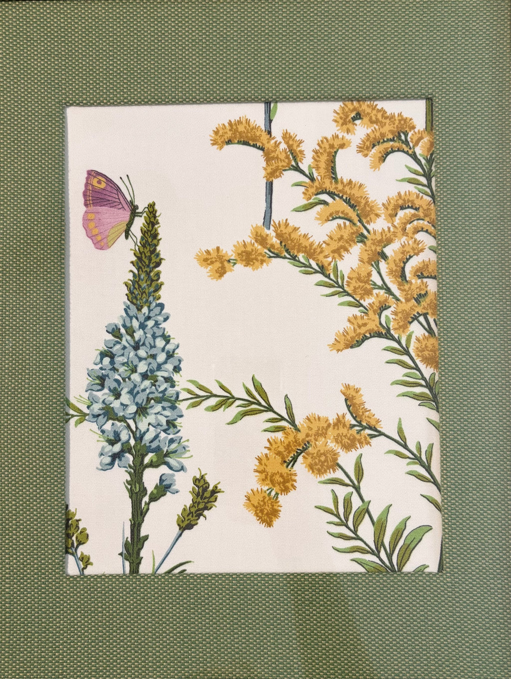 Butterfly and blue floral Isabella fabric composition surrounded by a textured Callen Green fabric mat.
