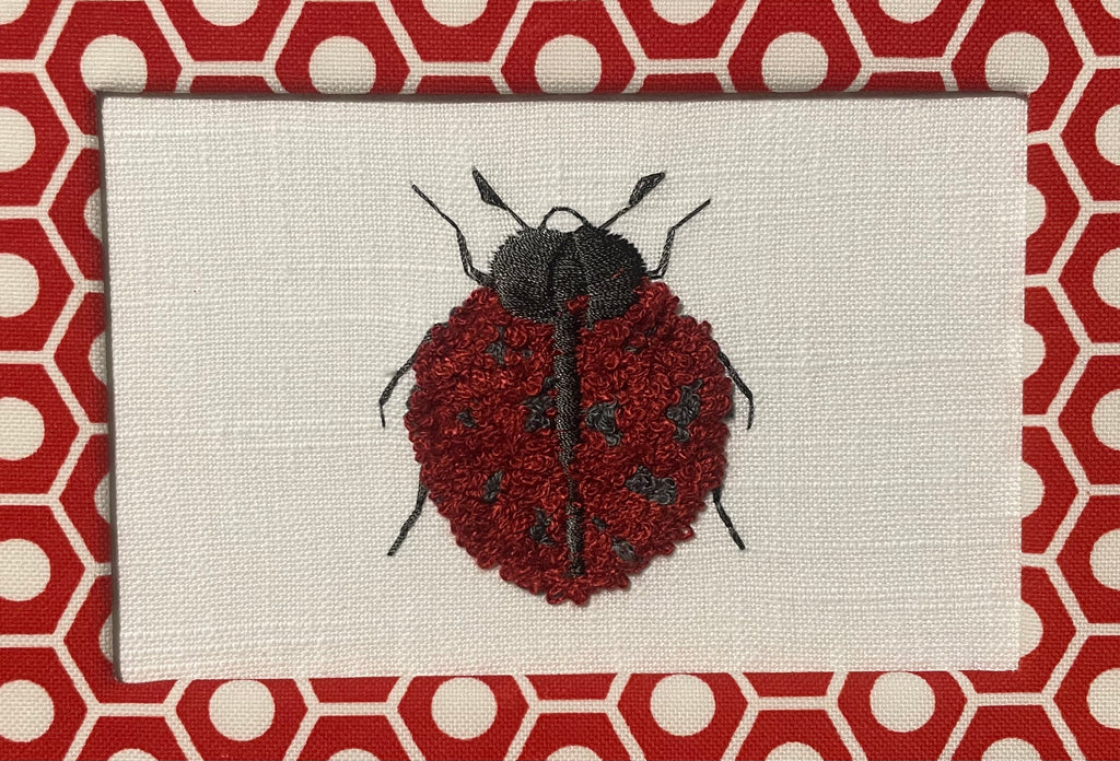 Embroidered Ladybug surrounded by Schumacher Queen B Custom Fabric Mat