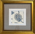 A framed square art print featuring a blue and gray botanical floral design on a cream background, surrounded by layered white textured mats and a wide gold-toned wooden frame.