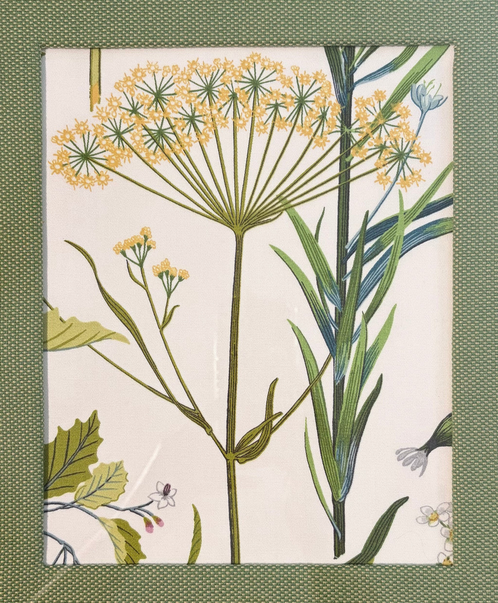 Yellow botanical Isabella fabric composition surrounded by a textured Callen Green fabric mat.