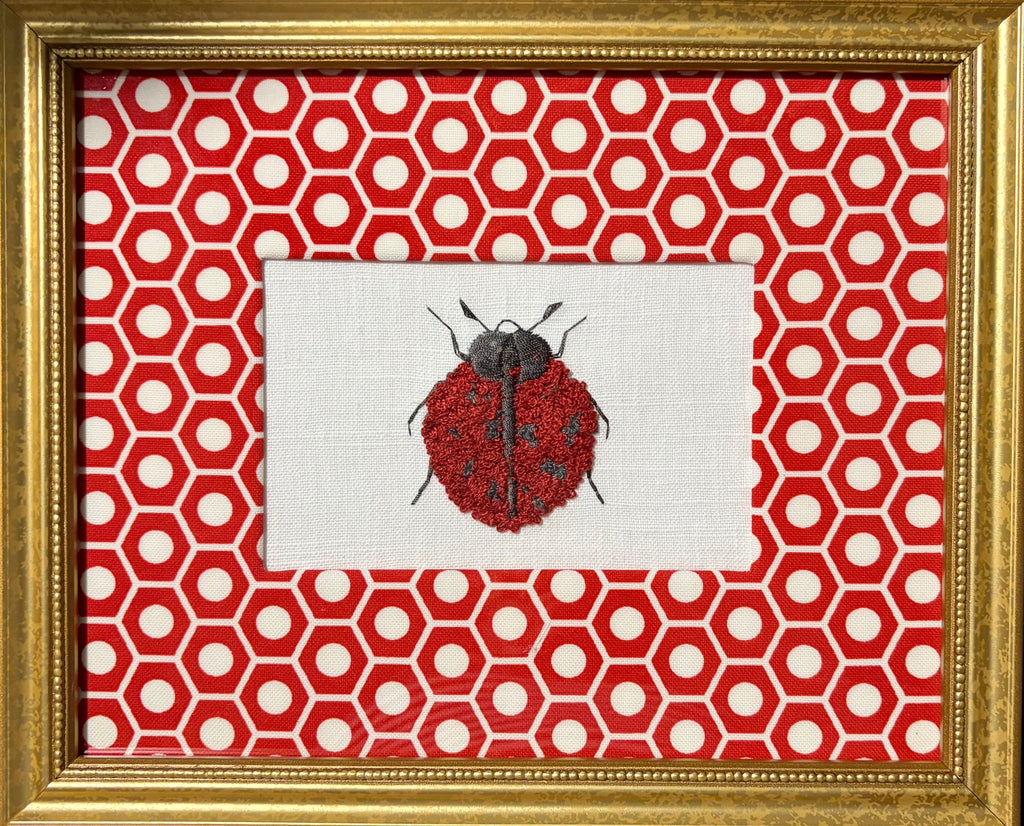 Embroidered Ladybug surrounded by Schumacher Queen B Custom Fabric Mat