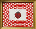 Embroidered Ladybug surrounded by Schumacher Queen B Custom Fabric Mat