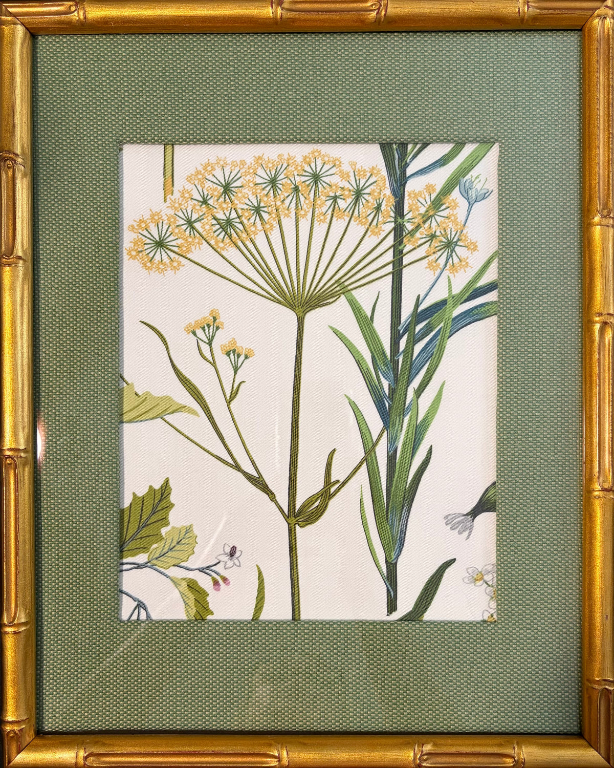 Front view of yellow botanical fabric art with green stems, a custom-made green mat and gold bamboo-style frame.