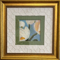 Framed floral artwork with a small central painting of white blossoms and a blue background, surrounded by layered white textured matting and a wide gold frame.