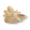 Gold insect-shaped object on a white background