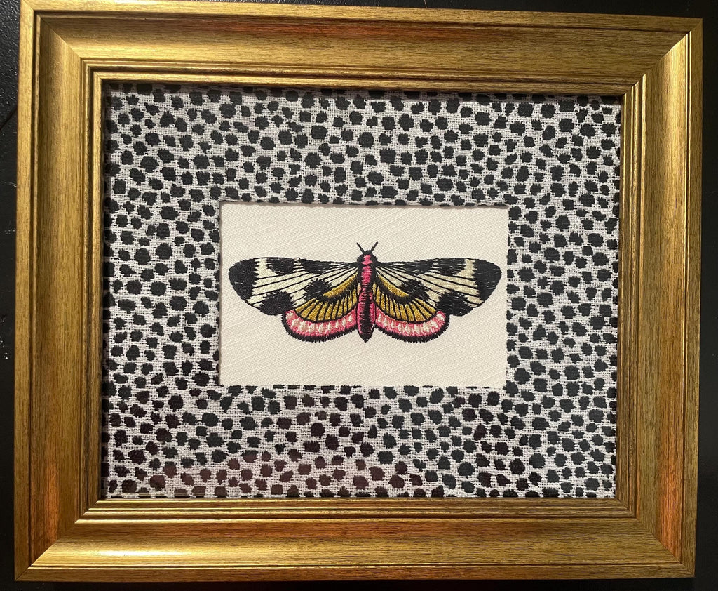 Embroidered Butterfly Moth surrounded by Ballard Designs Tully Ebony Fabric Mat