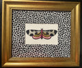 Embroidered Butterfly Moth surrounded by Ballard Designs Tully Ebony Fabric Mat