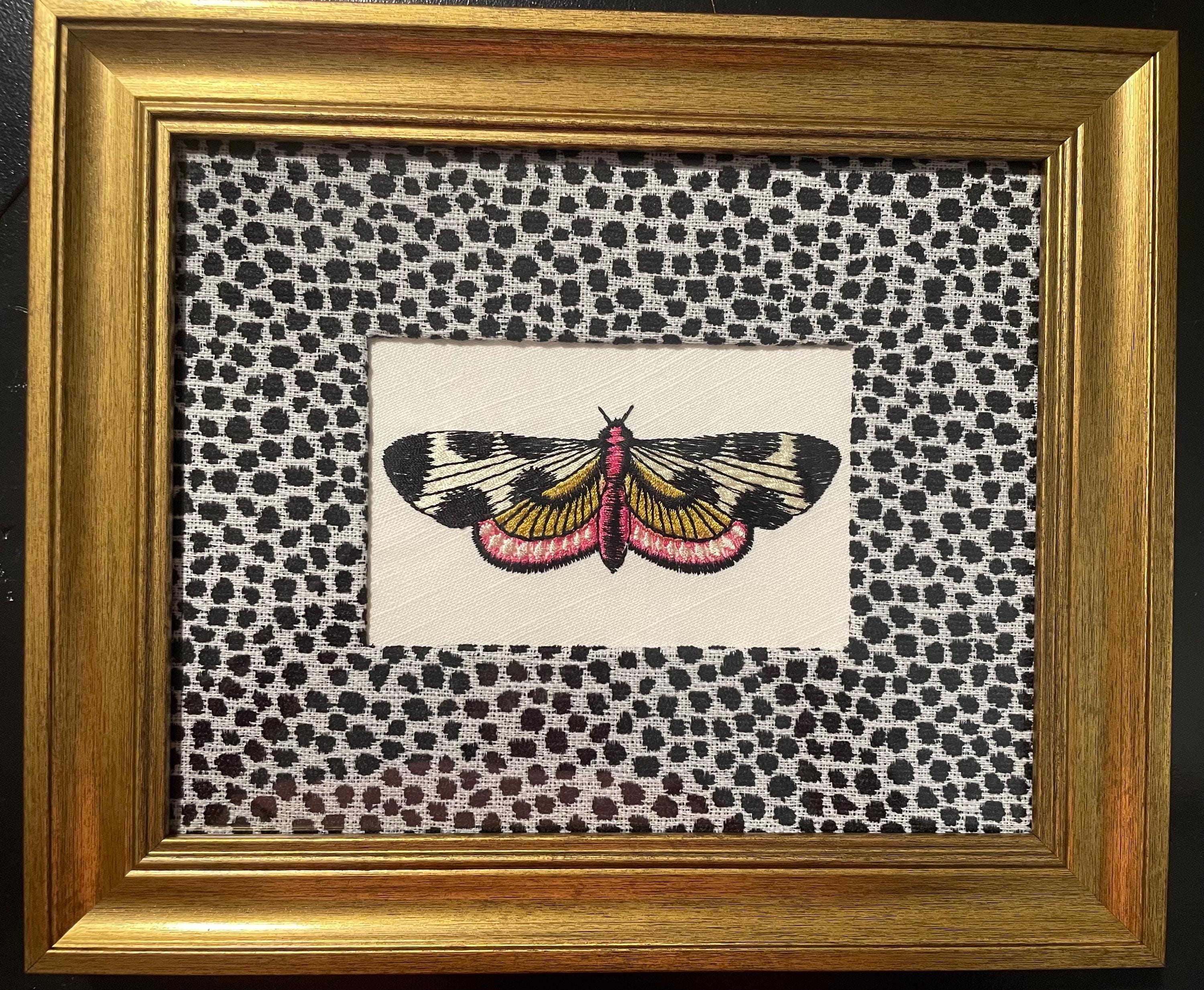 Embroidered Butterfly Moth surrounded by Ballard Designs Tully Ebony Fabric Mat