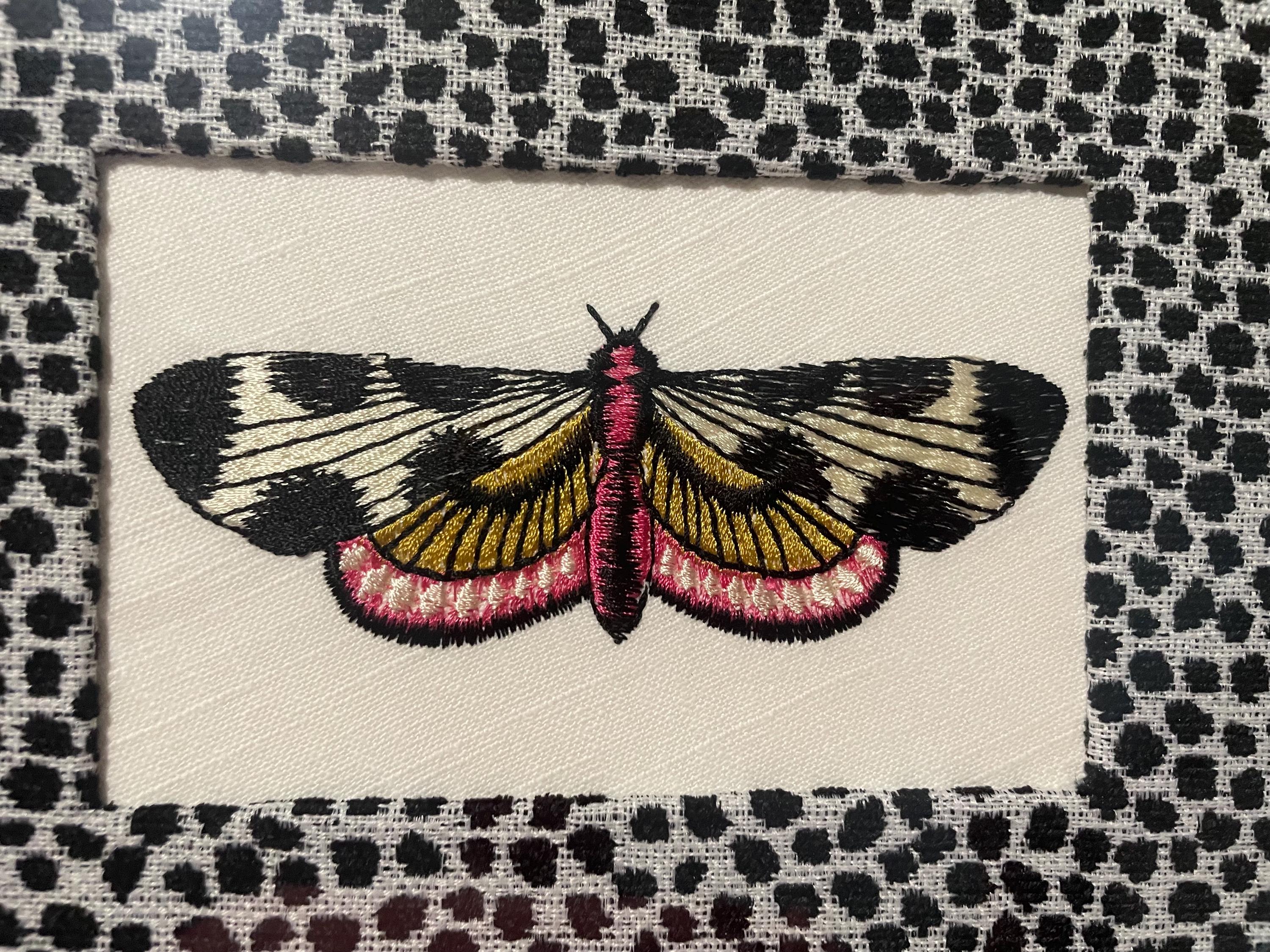 Embroidered Butterfly Moth surrounded by Ballard Designs Tully Ebony Fabric Mat