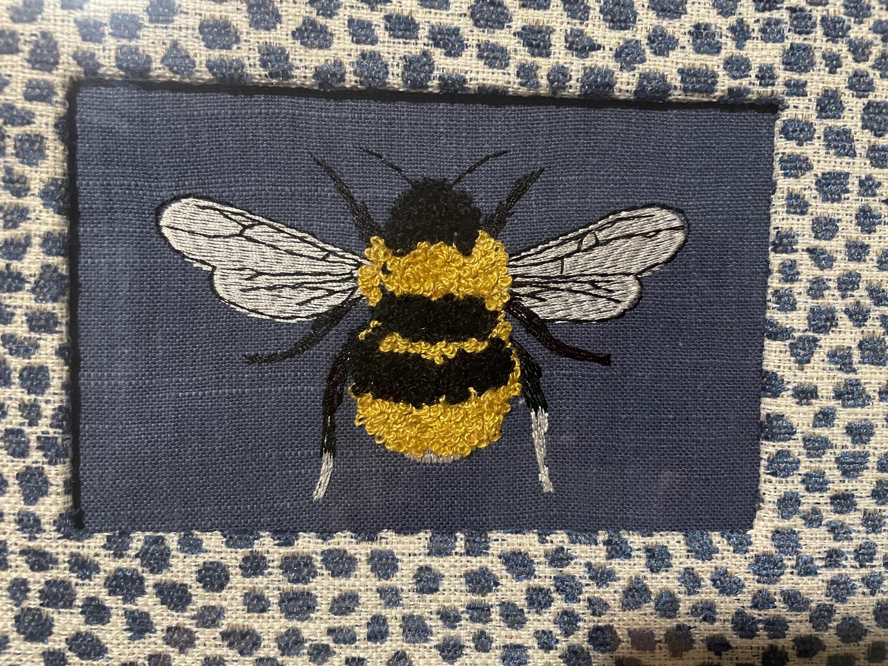 Adorable Bee surrounded by Ballard Designs Tully Blue Fabric Mat