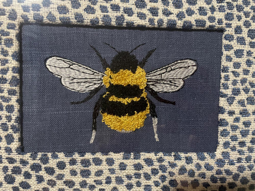 Adorable Bee surrounded by Ballard Designs Tully Blue Fabric Mat