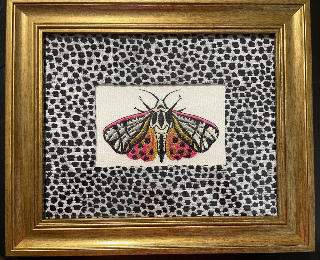 Embroidered Butterfly Moth surrounded by Ballard Designs Tully Ebony Fabric Mat