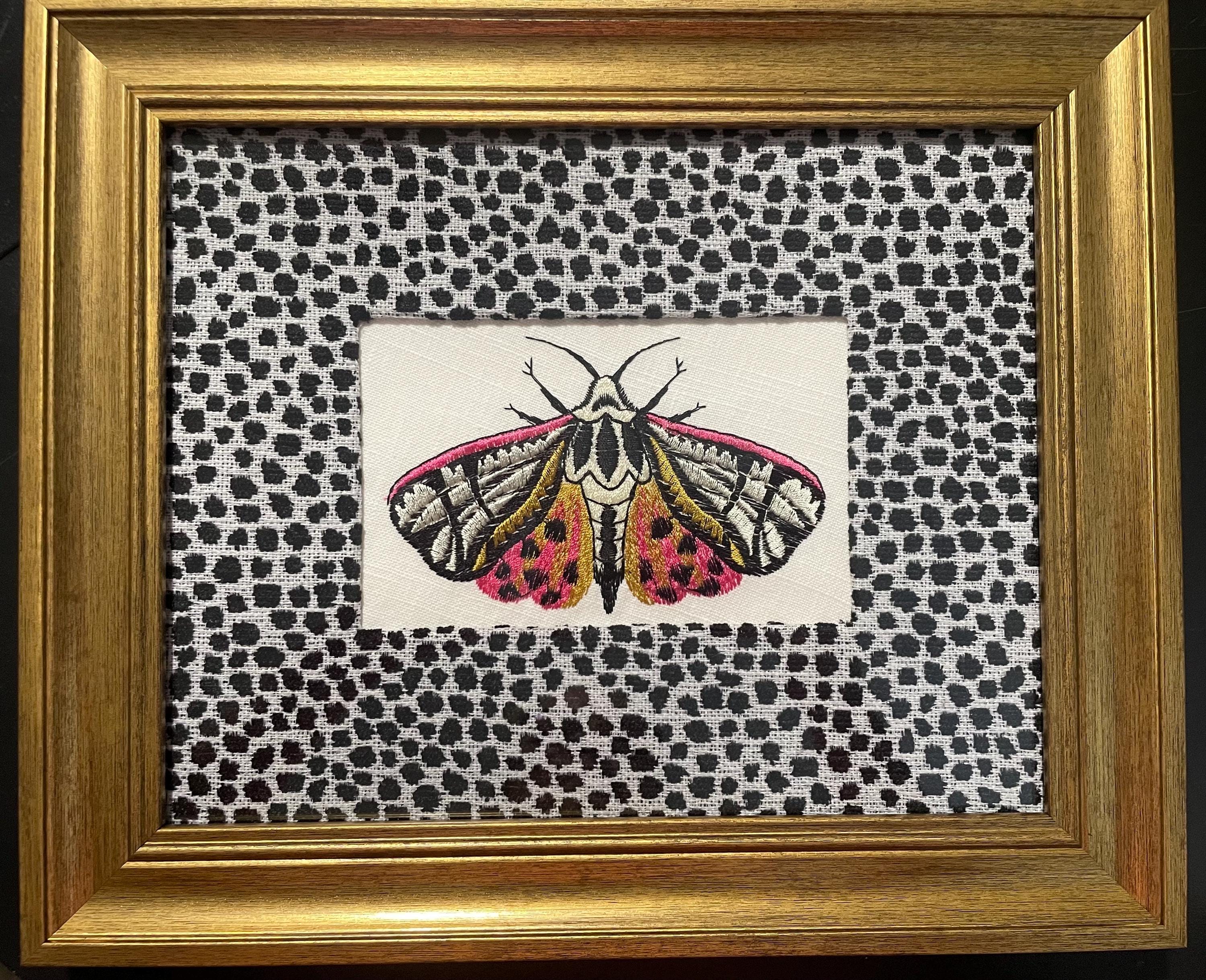 Embroidered Butterfly Moth surrounded by Ballard Designs Tully Ebony Fabric Mat