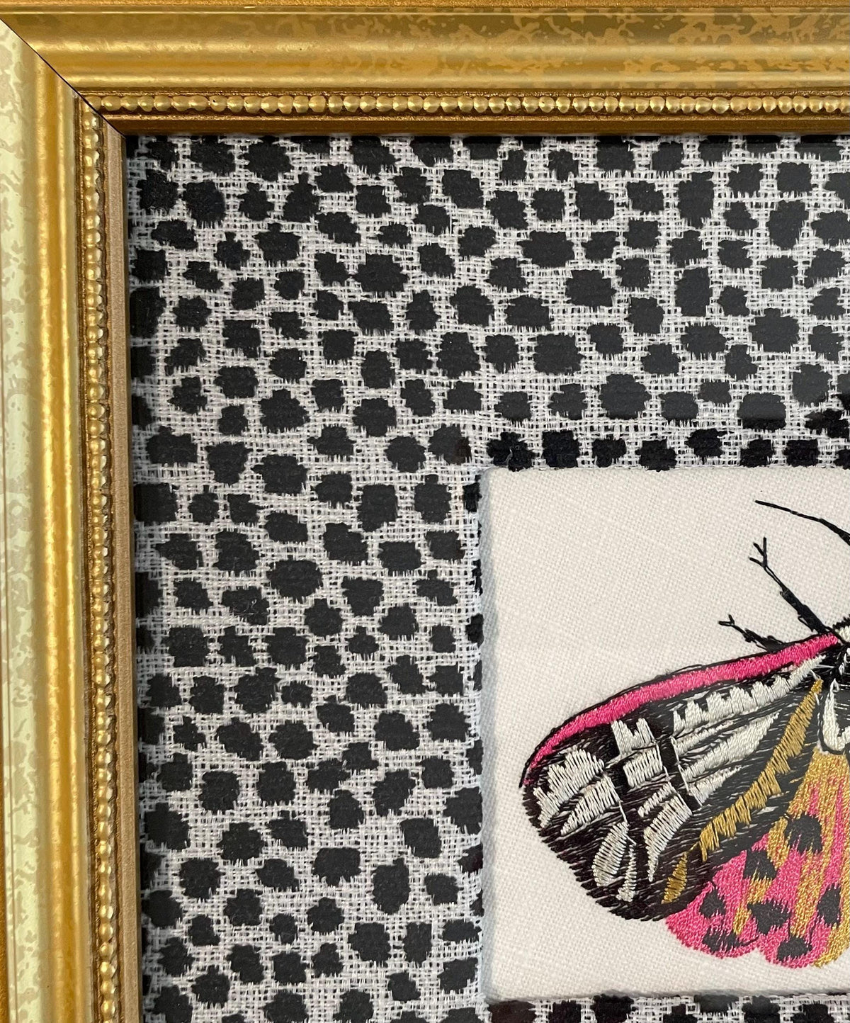 Embroidered Butterfly Moth surrounded by Ballard Designs Tully Ebony Fabric Mat