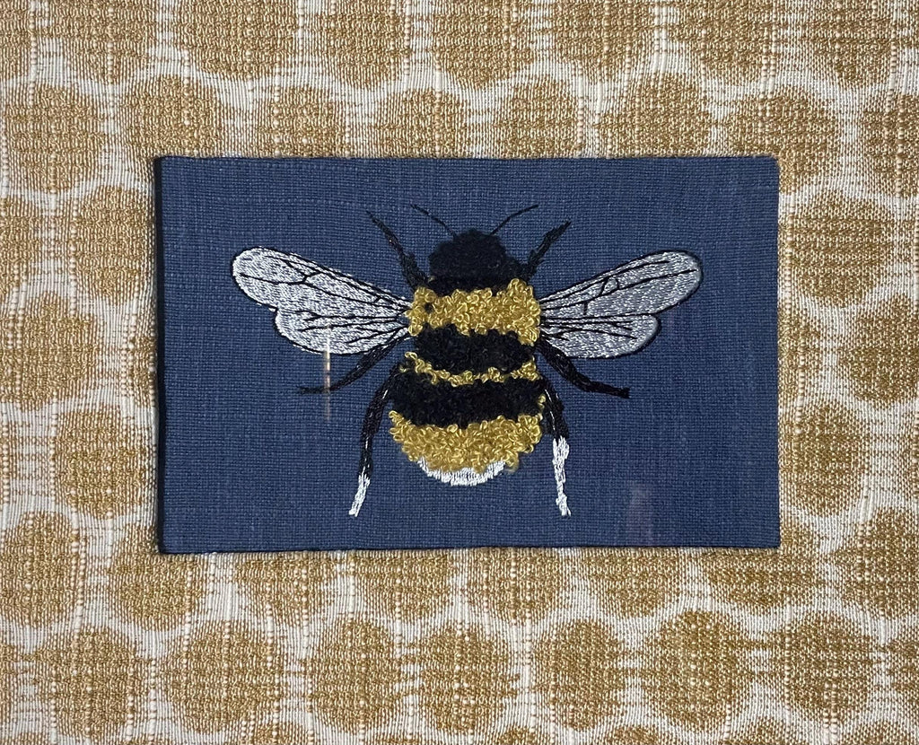 Mia Dijon Ballard Designs honeycomb fabric mat with adorable embroidered/boucle blue bee