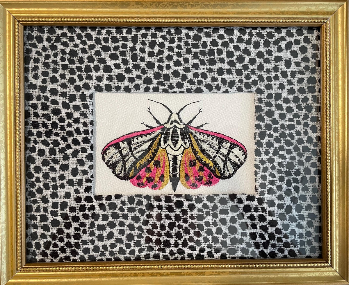Embroidered Butterfly Moth surrounded by Ballard Designs Tully Ebony Fabric Mat