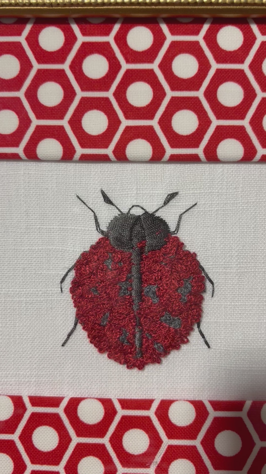 Embroidered Ladybug surrounded by Schumacher Queen B Custom Fabric Mat