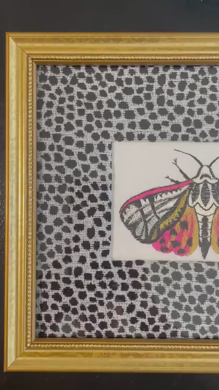 Embroidered Butterfly Moth surrounded by Ballard Designs Tully Ebony Fabric Mat
